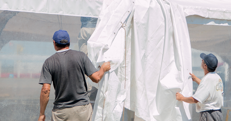 People setting up a marquee