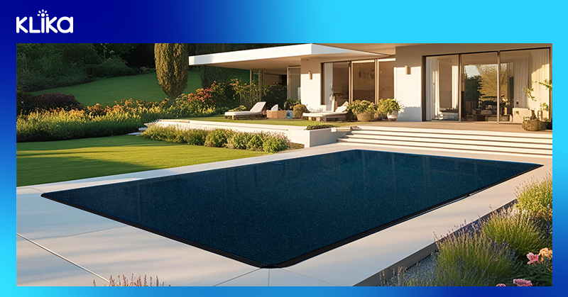 A pool cover laid out on a pool
