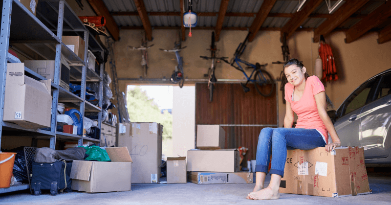 Young woman sitting in a half-organised garage